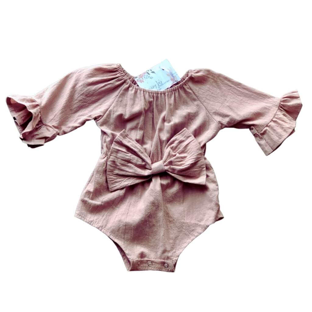 baby girl dusty pink  bell-sleeved linen romper with box detail in the front.