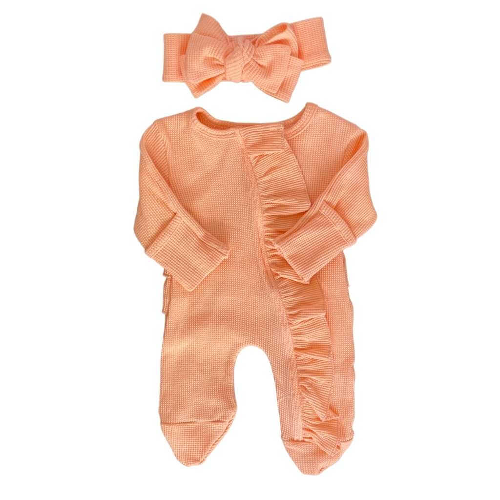 newborn baby girl coral ruffled sleeper with headband. Sassy Jo's Babies and bows